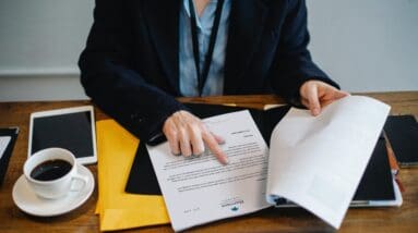 Person turning pages on desk