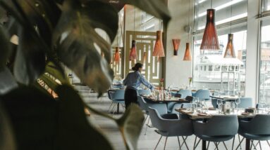 Woman setting a table in restaurant