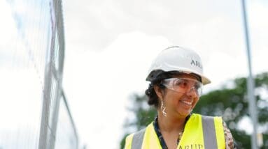 Woman wearing hard hat and yellow vest