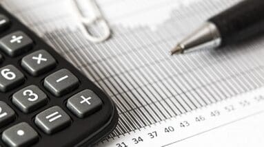 Calculator and Pen on Table