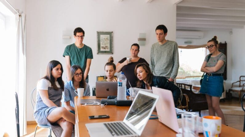 Group of people watching laptop